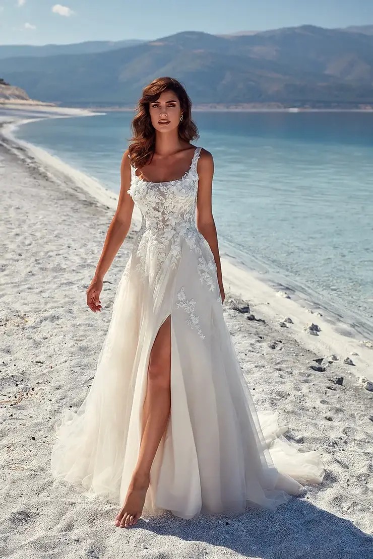 Model wearing a bridal gown on the beach